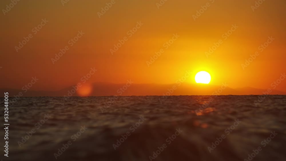 Sunset time above the ocean, water surface in slow motion at sunset time, nature background static shot Sunset time above the ocean, water surface in slow motion at sunset time, nature background static shot