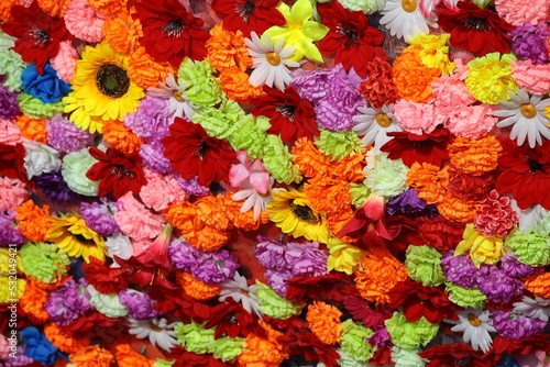 Colorful background of artificial flowers