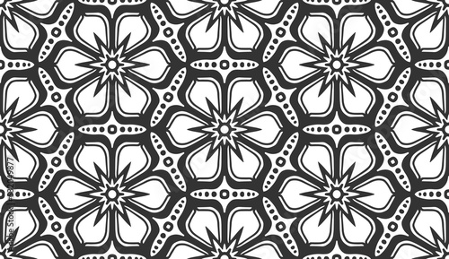 Seamless flower pattern. Abstract geometric floral black and white texture. Vintage fashion fabric ornament, carpet, wallpaper, packaging wrapping paper print. Monochrome lace hexagonal tile design