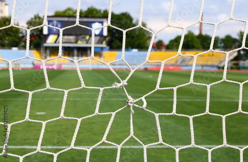 Close-up torn goal net  details of football soccer stadium. View behind the net