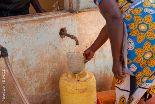Fényképezés African woman fetching water