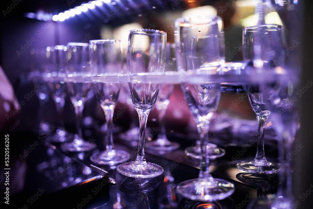 wine glasses in shelf above a bar rack in restaurant wine glasses in shelf above a bar rack in restaurant
