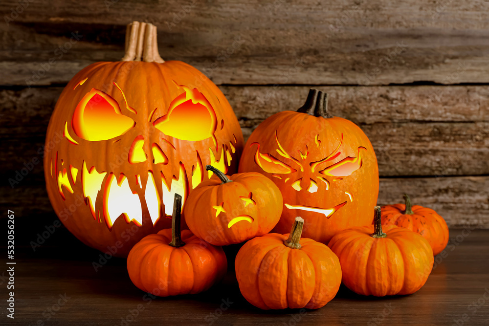 Spooky jack o`lanterns on wooden table. Halloween decor Spooky jack o`lanterns on wooden table. Halloween decor