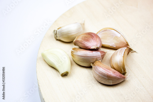 Natural garlic on a wooden board. Heads of unprepared garlic.