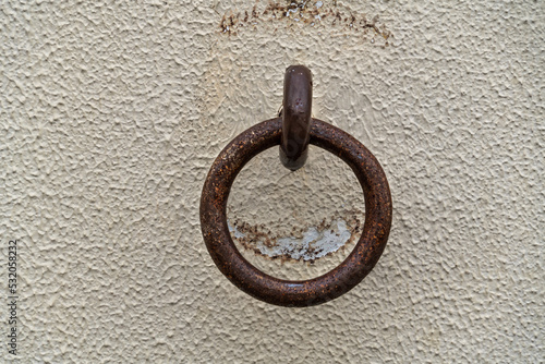 old iron ring is on a wall.