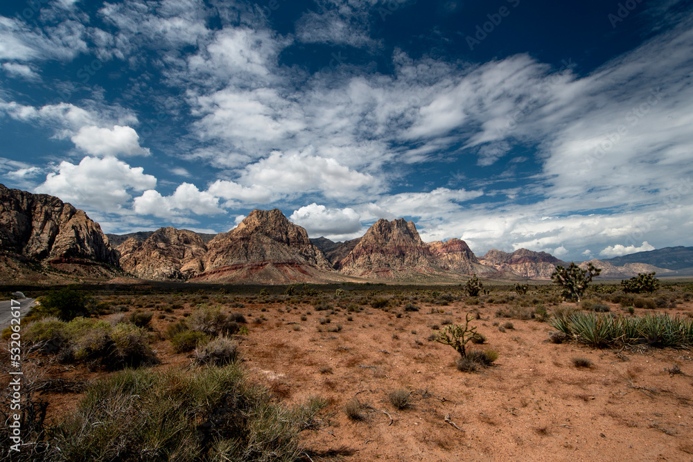 Desert mountains with intense clouds moving over landscape