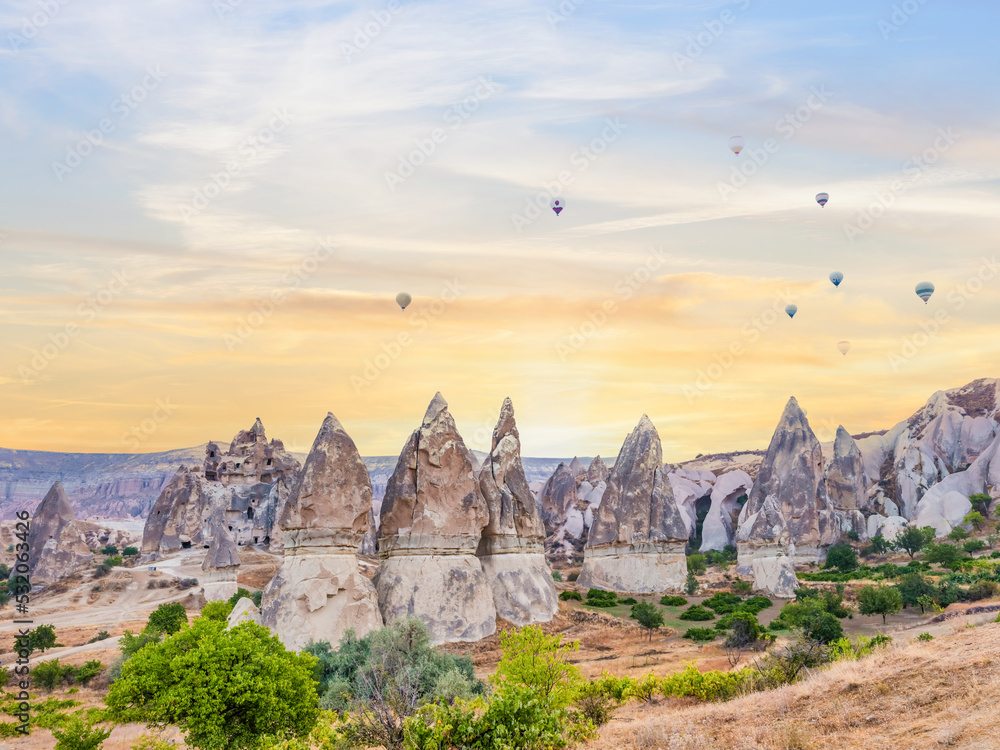 fairy chimneys castles rock fortresses with flying hot air balloon at cappadocia turkey