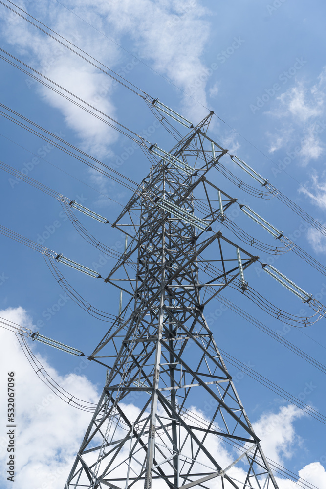 electricity transmission pylon against blue sky. high voltage electricity pole.