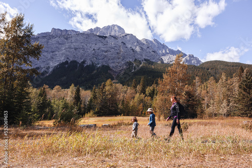 Mother and children walking in the mountains in Autumn
