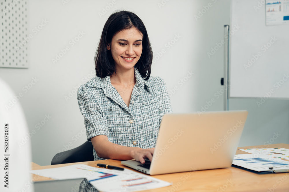 Successful businesswoman working with laptop at her office desk, Concept of business risk analysis and assessment Successful businesswoman working with laptop at her office desk, Concept of business risk analysis and assessment