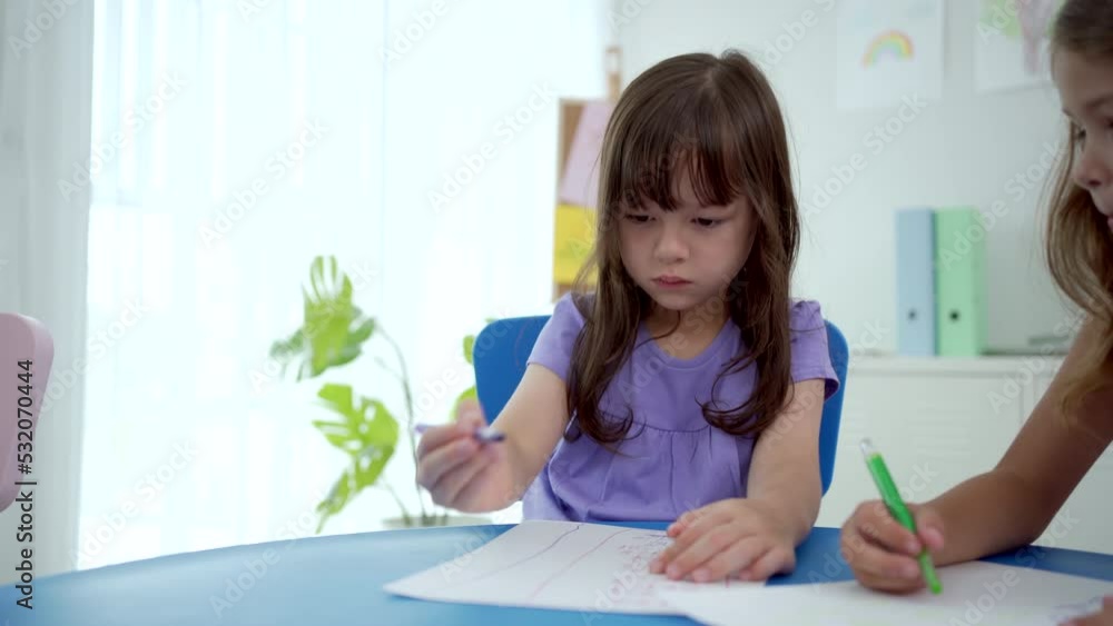Little kids enjoy drawing or painting in classroom. Little kids enjoy drawing or painting in classroom.