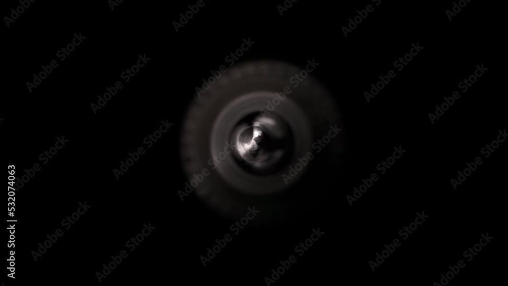 Industrial themed background and wallpaper with copyspace and central composition. A drill chuck with a drill for metal or wood close-up rotates on a black background. Front view Industrial themed background and wallpaper with copyspace and central composition. A drill chuck with a drill for metal or wood close-up rotates on a black background. Front view