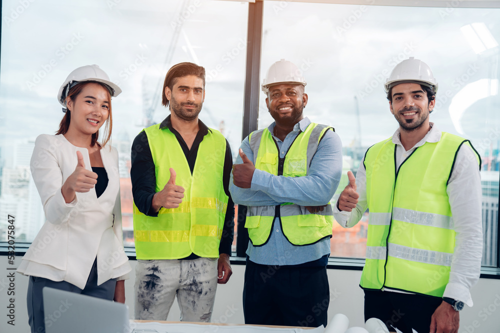 Portrait of Architector and engineers with draft plan of building and laptop on constructing site, teamwork. Portrait of Architector and engineers with draft plan of building and laptop on constructing site, teamwork.