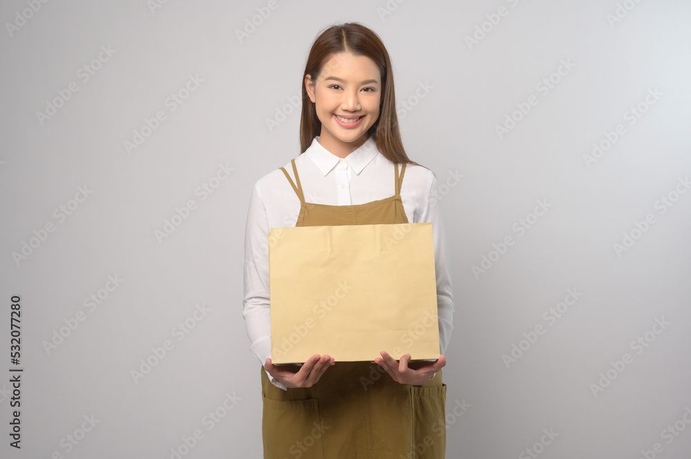 Portrait of young asian woman wearing apron over white background studio, cooking and entrepreneur concept Portrait of young asian woman wearing apron over white background studio, cooking and entrepreneur concept