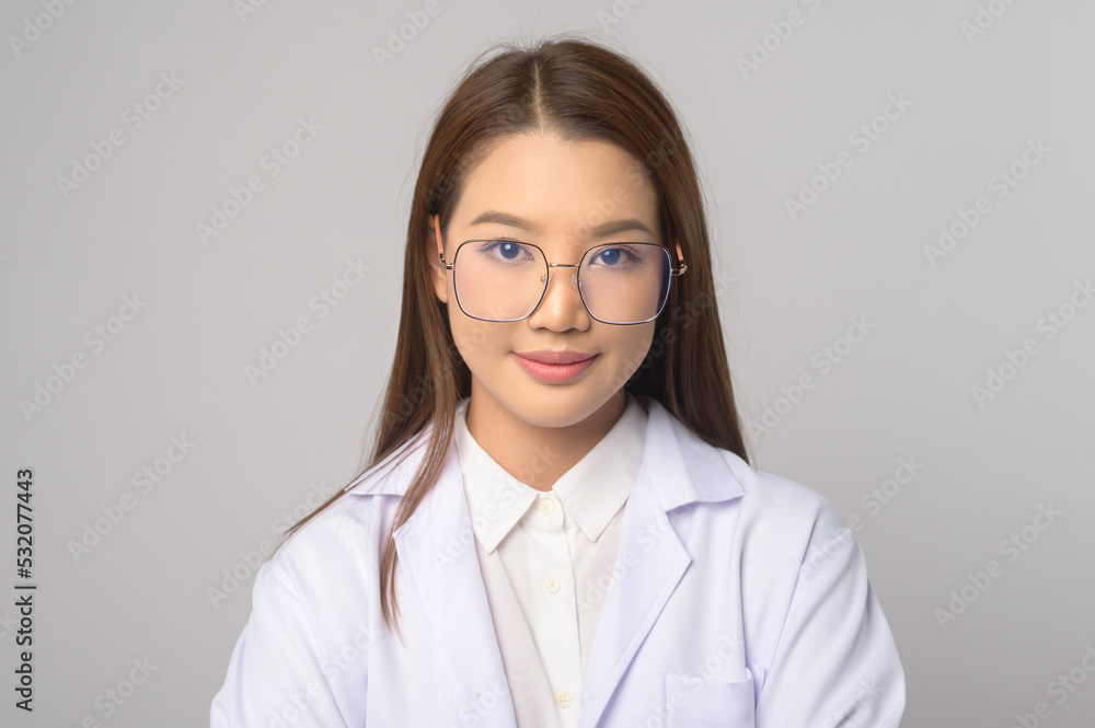 Young female ophthalmologist with glasses holding eye chart over blue background studio, healthcare concept. Young female ophthalmologist with glasses holding eye chart over blue background studio, healthcare concept.