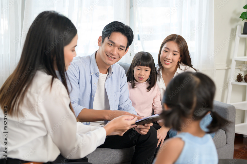 Asian family meeting with female real estate agent or insurance consultant offering promotions , Mortgage, loan, property and medical health insurance concept. Asian family meeting with female real estate agent or insurance consultant offering promotions , Mortgage, loan, property and medical health insurance concept.