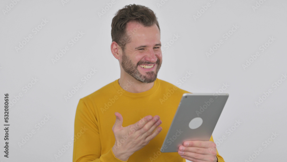 Middle Aged Man Celebrating on Tablet in Office , White Background Middle Aged Man Celebrating on Tablet in Office , White Background