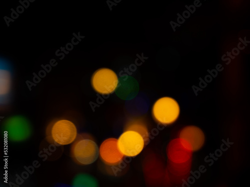 Light Night Bokeh dark Black Background,Abstract Orange Red Colorful Circle Effect Sparkle Blurry Backdrop,for Invitation Special Gala,Birthday Card,Christmas Holidays Celebration,Happy New Year 2023. © wing-wing