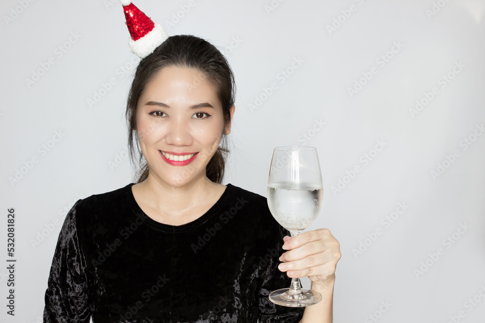 Asian beautiful woman holds champaign glass to celebrate new year party with smile and happiness Asian beautiful woman holds champaign glass to celebrate new year party with smile and happiness