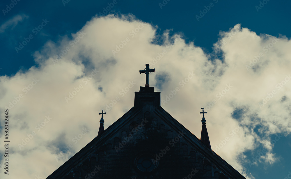 Church tower with crosses silhouetted against cloudy sky. Church tower with crosses silhouetted against cloudy sky.