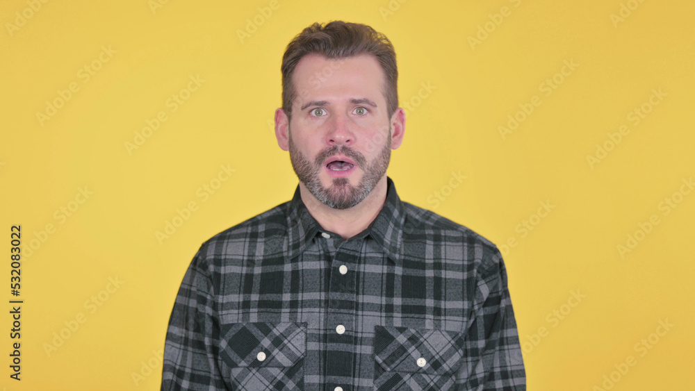 Middle Aged Man Feeling Shocked, Yellow Background Middle Aged Man Feeling Shocked, Yellow Background