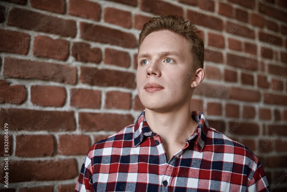 young man by brick wall young man by brick wall