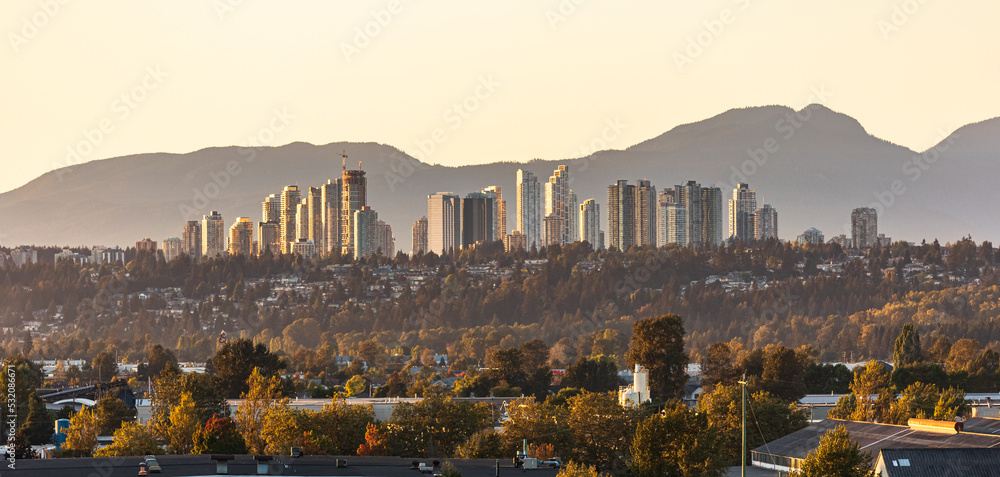 Fototapeta premium View of Burnaby, Greater Vancouver area on a sunset with mountains at the background.