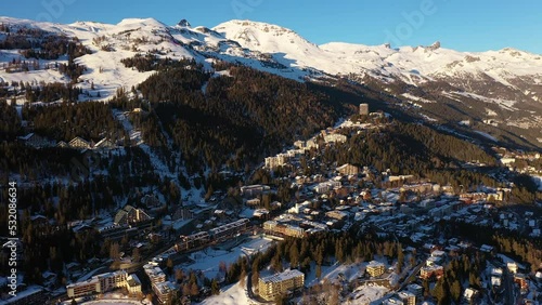 Aerial footage of the Crans-Montana village and ski resort in Canton Valais in the alps in Switzerland in winter. Shot with a rotation motion photo