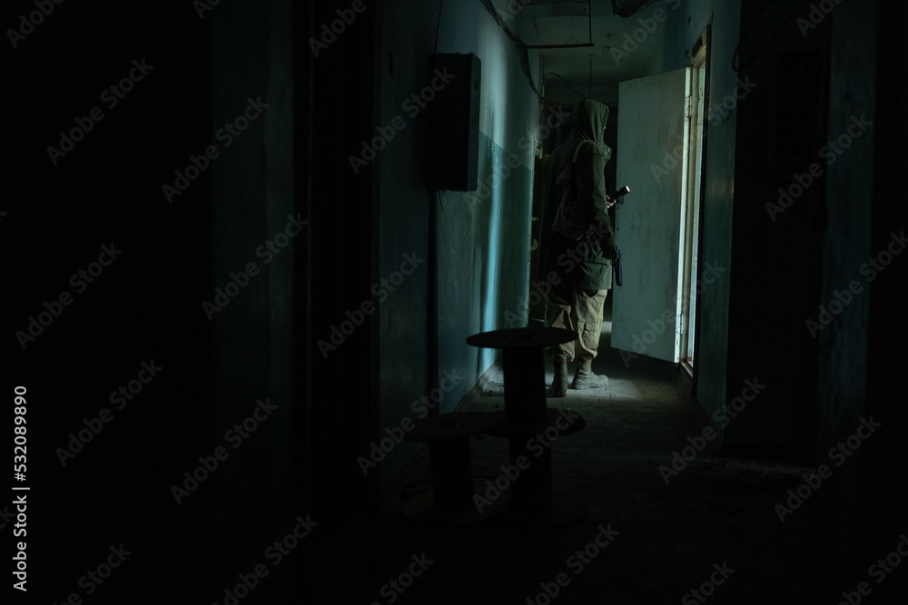 a man walking in a dark corridor of abandoned build, with flashlight in dark a man walking in a dark corridor of abandoned build, with flashlight in dark