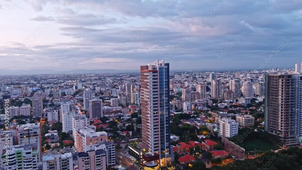 Evening South Point Tower in front of Mirador Sur Park. National District., Santo Domingo, Dominican Republic - Drone shot orbit Evening South Point Tower in front of Mirador Sur Park. National District., Santo Domingo, Dominican Republic - Drone shot orbit