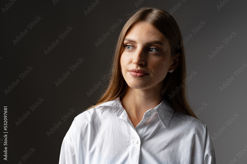 Thoughtful businesswoman portrait on a dark gray background Thoughtful businesswoman portrait on a dark gray background