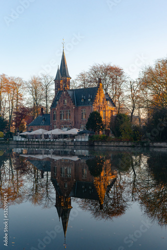 Minnewater lake , Minnewaterbrug . Beautiful lake and garden in old town of Brugge during autumn , winter : Brugge , Belgium : November 30 , 2019