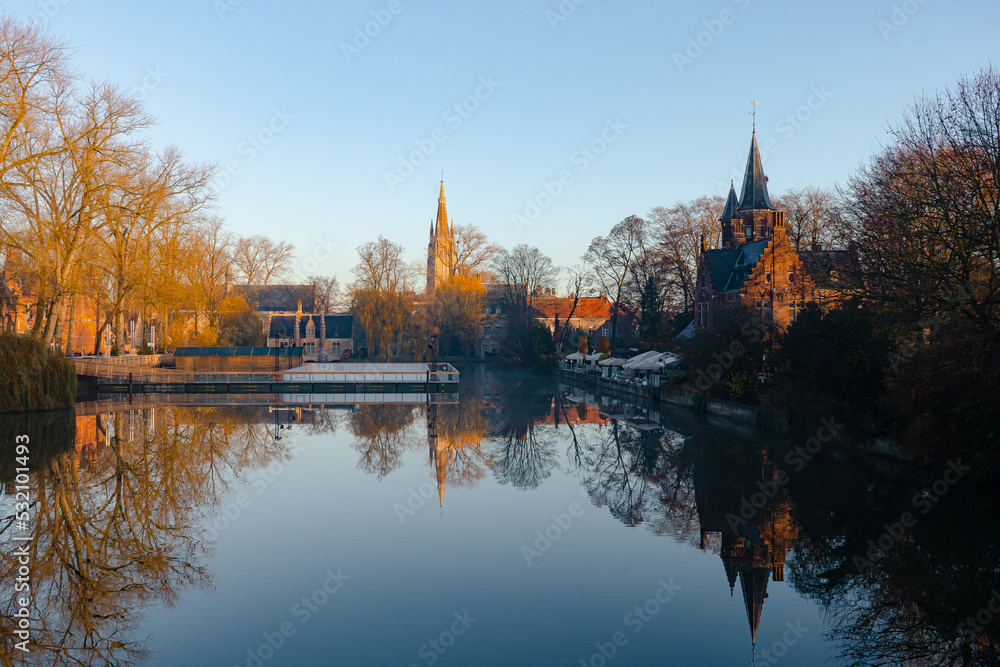 Minnewater lake , Minnewaterbrug . Beautiful lake and garden in old town of Brugge during autumn , winter : Brugge , Belgium : November 30 , 2019
