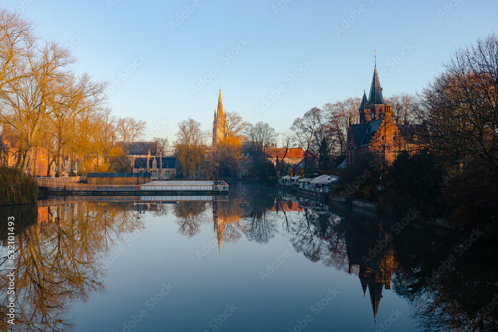Minnewater lake , Minnewaterbrug . Beautiful lake and garden in old town of Brugge during autumn , winter : Brugge , Belgium : November 30 , 2019 Minnewater lake , Minnewaterbrug . Beautiful lake and garden in old town of Brugge during autumn , winter : Brugge , Belgium : November 30 , 2019