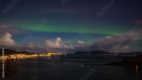 Static shot of northern lights over Alesund Town in More Og Romsdal, Norway at night time in timelapse. photo