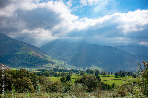 Cloudy sky and rays of light falling on the mountains of the valleys of Pas in Vega de Pas  Cantabria-Spain 