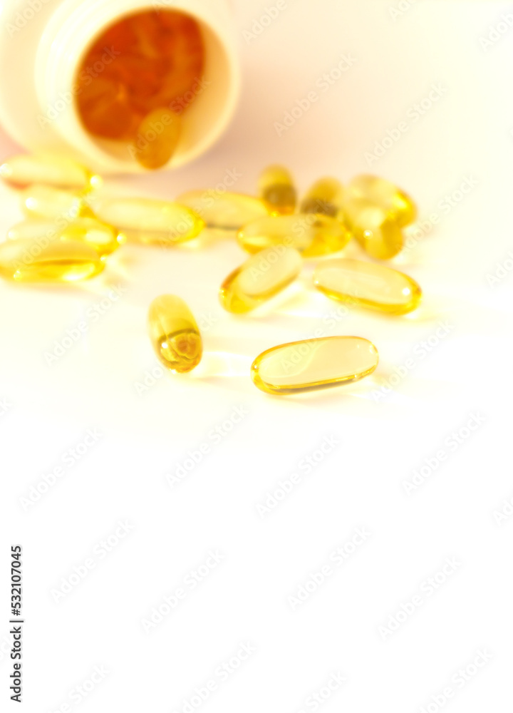 Fish oil pills. Omega 3 gel capsules with bottle on blurred background Fish oil pills. Omega 3 gel capsules with bottle on blurred background