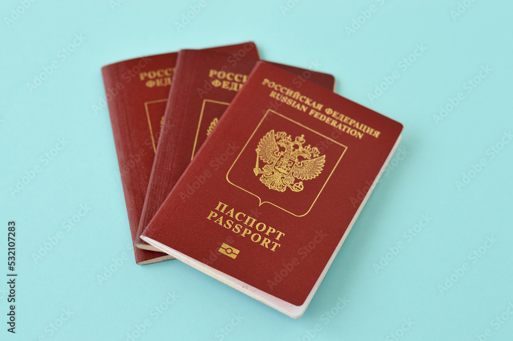 The foreign passport of the Russian Federation on blue backgound. The concept of imposing sanctions and restrictions on international migration. The foreign passport of the Russian Federation on blue backgound. The concept of imposing sanctions and restrictions on international migration.