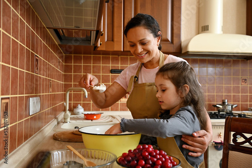 Bild auf Leinwand Beautiful African American young woman in chef apron, loving mom smiling and hug