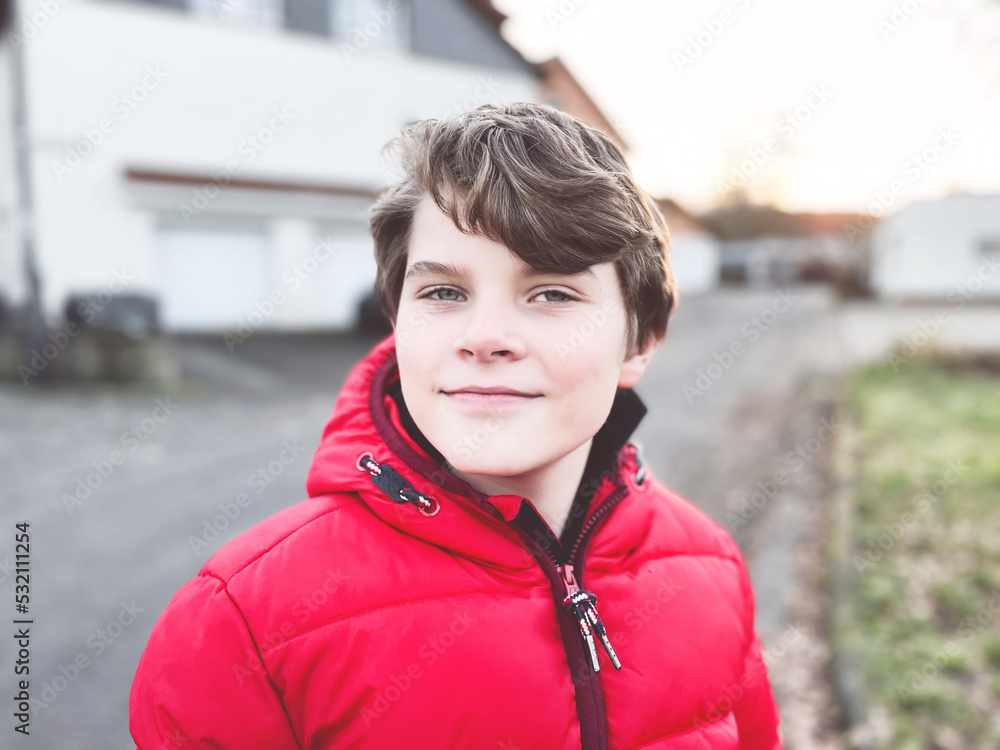 Portrait of little school kid boy. Beautiful happy child looking at the camera. Schoolboy smiling. Education concept.