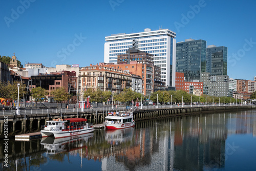 A section of the Paseo de Uribitarte in Bilbao shot from the other side of the river Nervion on a sunny day © drew