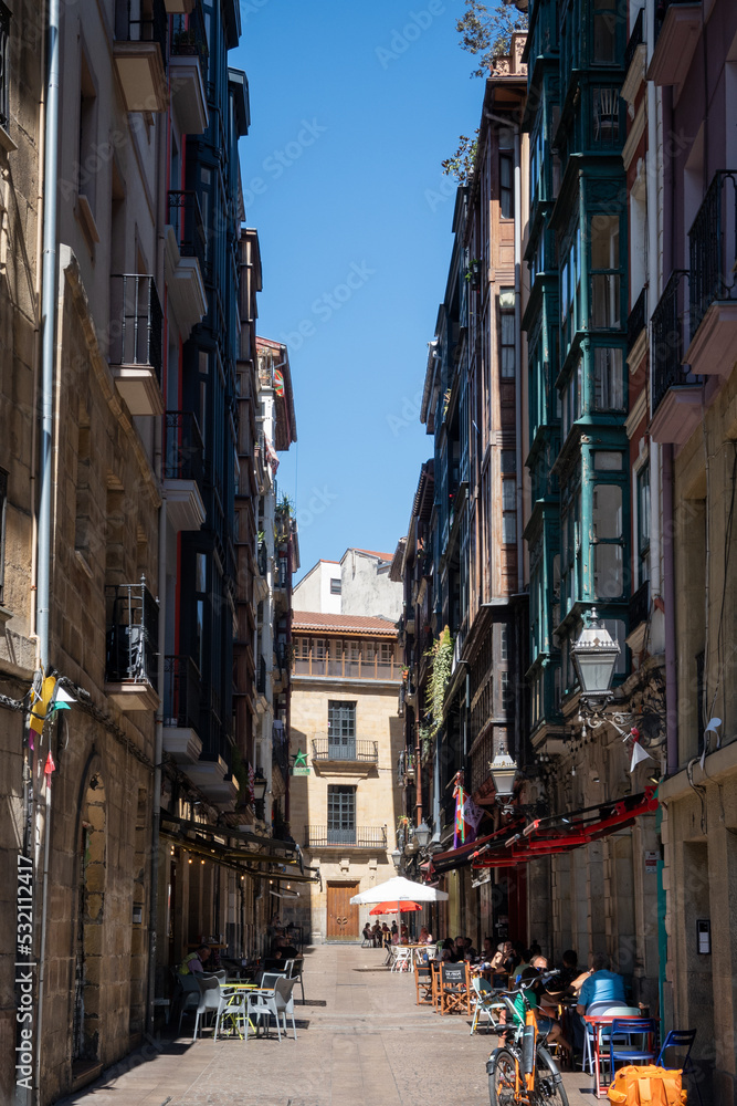 Fototapeta premium Bilbao, Spain, Sept 11th 2022. A street in the Matiko neighbourhood is relaxed during the day but lively with food drink and music during the evening