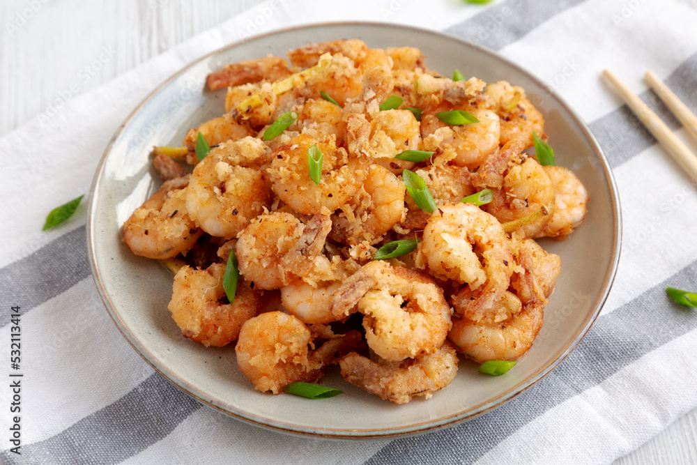 Homemade Crispy Salt and Pepper Shrimp with Scallions on a Plate, side view. Close-up. Homemade Crispy Salt and Pepper Shrimp with Scallions on a Plate, side view. Close-up.