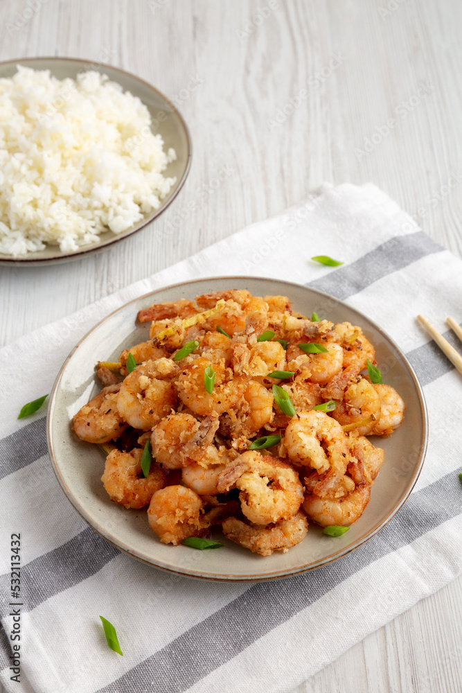 Homemade Crispy Salt and Pepper Shrimp with Scallions on a Plate, side view. Homemade Crispy Salt and Pepper Shrimp with Scallions on a Plate, side view.