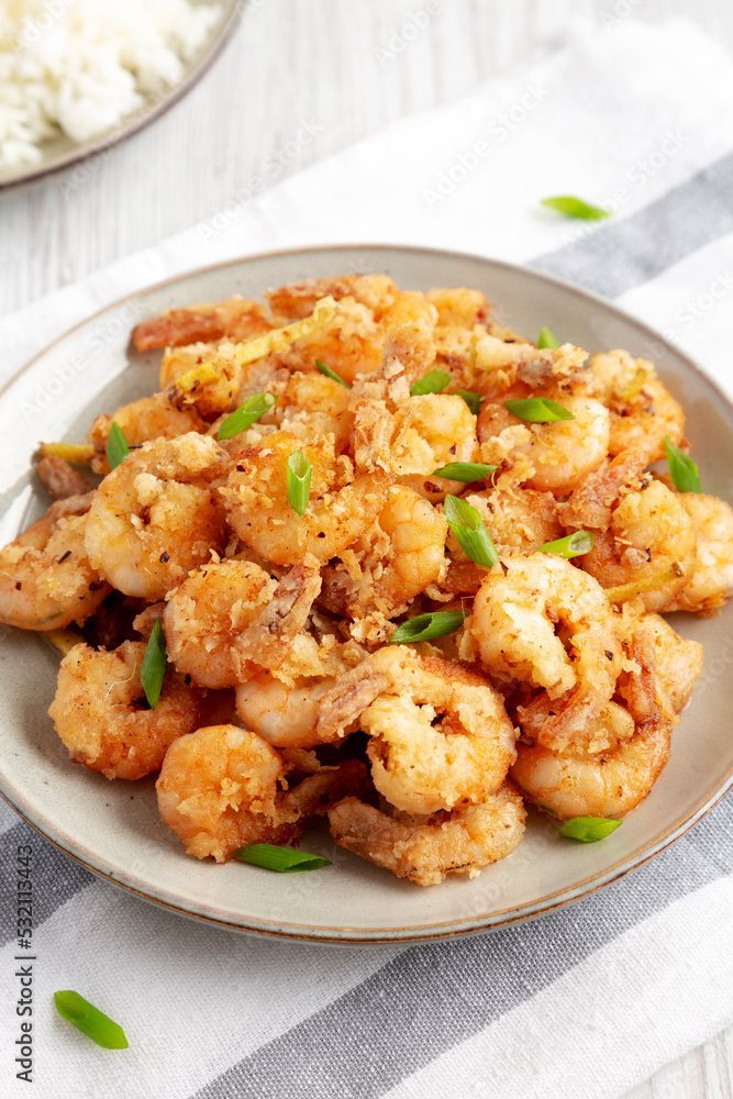 Homemade Crispy Salt and Pepper Shrimp with Scallions on a Plate, side view. Homemade Crispy Salt and Pepper Shrimp with Scallions on a Plate, side view.