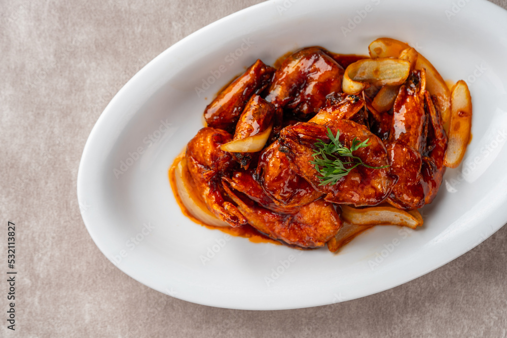 shrimp with butter sauce (Indonesia : udang saus mentega). Plating on white plate shrimp with butter sauce (Indonesia : udang saus mentega). Plating on white plate