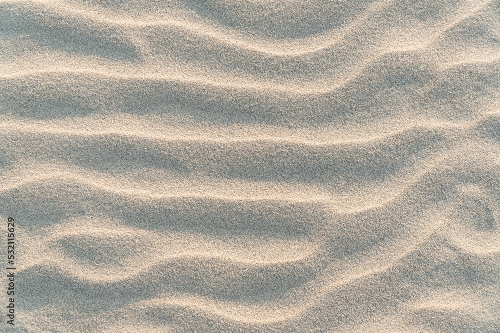 Wavy nature sand background. Yellow desert sand texture. Nature beige dune backdrop. Overlay texture. Grunge background. High resolution texture. Copy space for design and text. Wavy nature sand background. Yellow desert sand texture. Nature beige dune backdrop. Overlay texture. Grunge background. High resolution texture. Copy space for design and text.