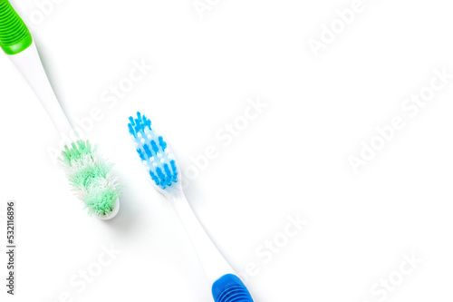 Used and new toothbrushes shot side by side for comparison.