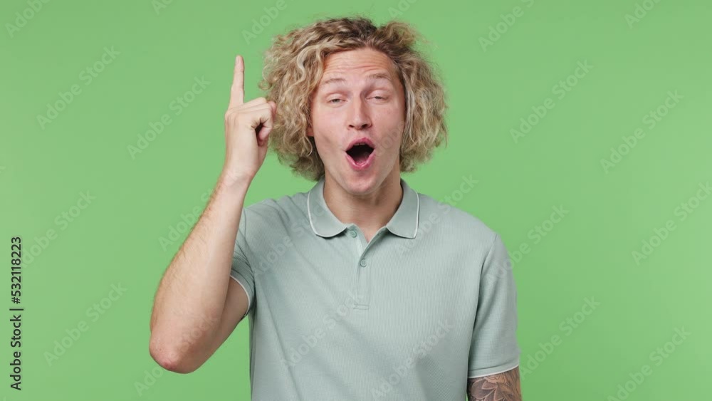 Young excited insighted puzzled pensive blond man wear blue t-shirt looks around thinks scratches at temple comes up with ideas raised finger get plan isolated on plain pastel light green background Young excited insighted puzzled pensive blond man wear blue t-shirt looks around thinks scratches at temple comes up with ideas raised finger get plan isolated on plain pastel light green background