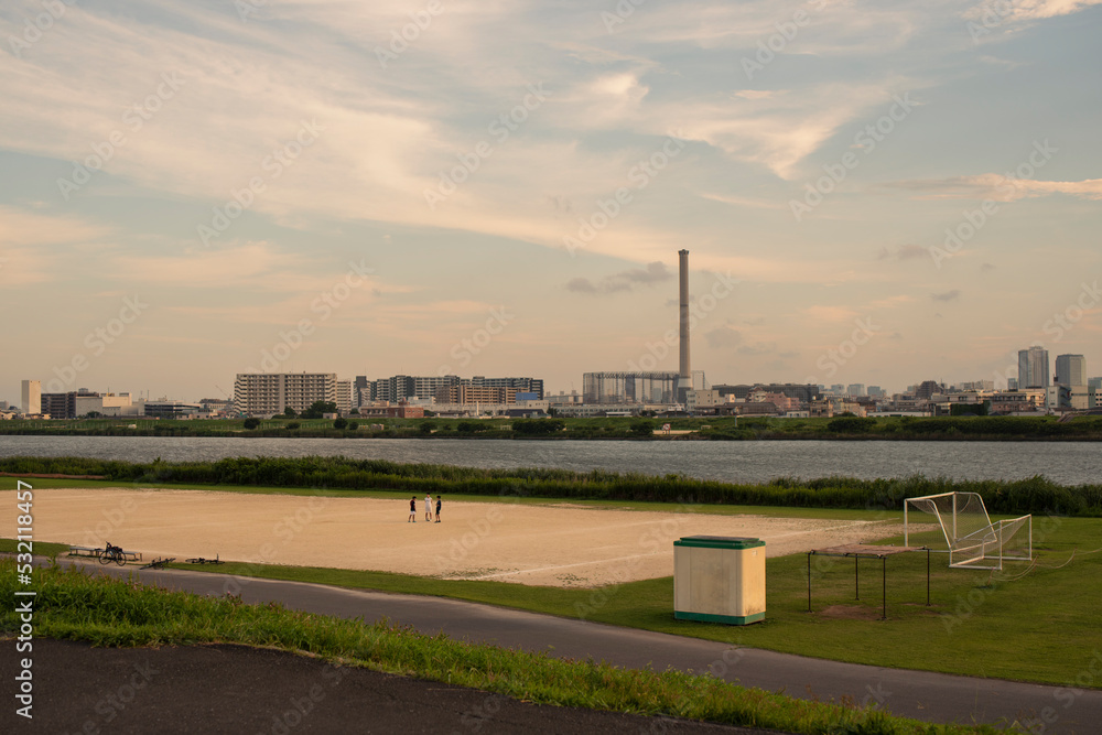 Fototapeta premium 夕方 河川敷で遊ぶ小学生